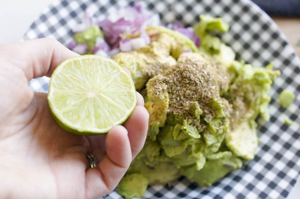 Lime Lovin' Guacamole Ingredients in bowl with lime